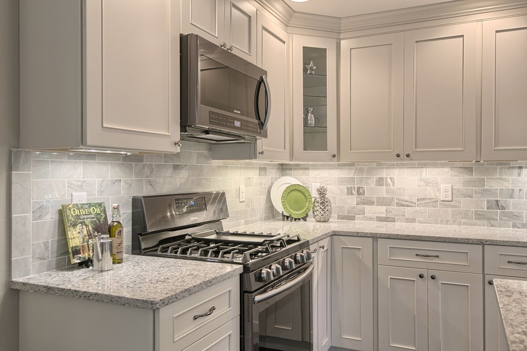 5 Davis Road Chelmsford, MA 01824 - Photo 5 of 27 a kitchen with granite countertop a stove top oven microwave and cabinets