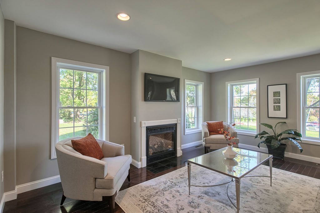 5 Davis Road Chelmsford, MA 01824 - Photo 9 of 27 a living room with furniture a fireplace a lamp and a window