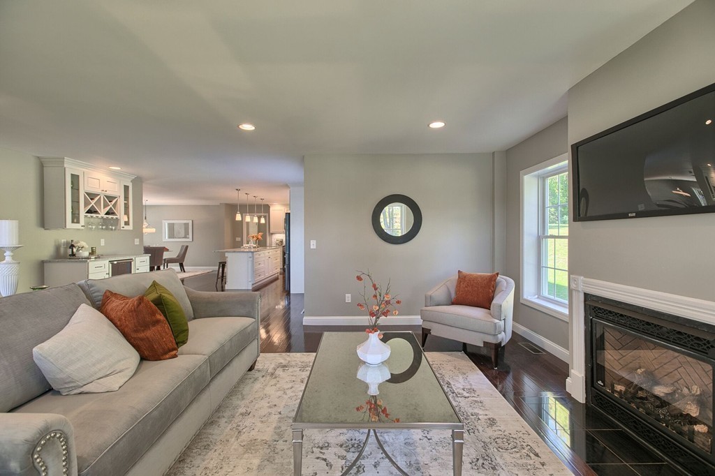 5 Davis Road Chelmsford, MA 01824 - Photo 10 of 27 a living room with furniture flat screen tv and a fireplace