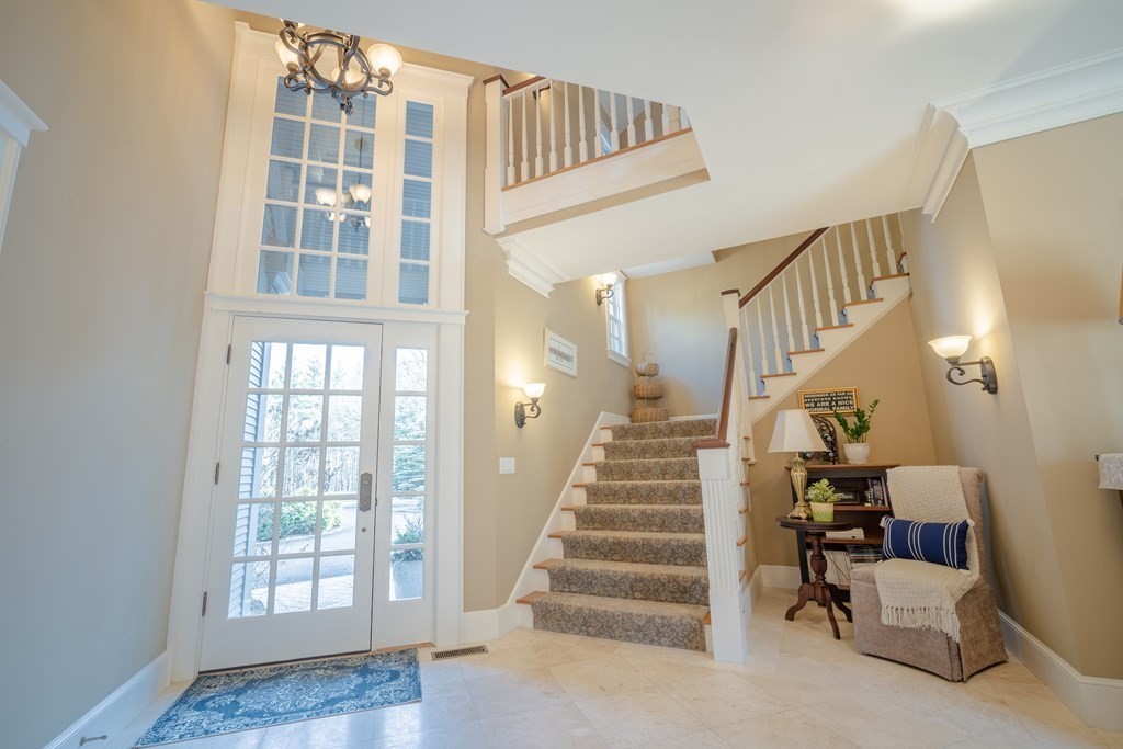 145 Dutton Road Sudbury, MA 01776 - Photo 18 of 41 a view of staircase with lots of frames and couches