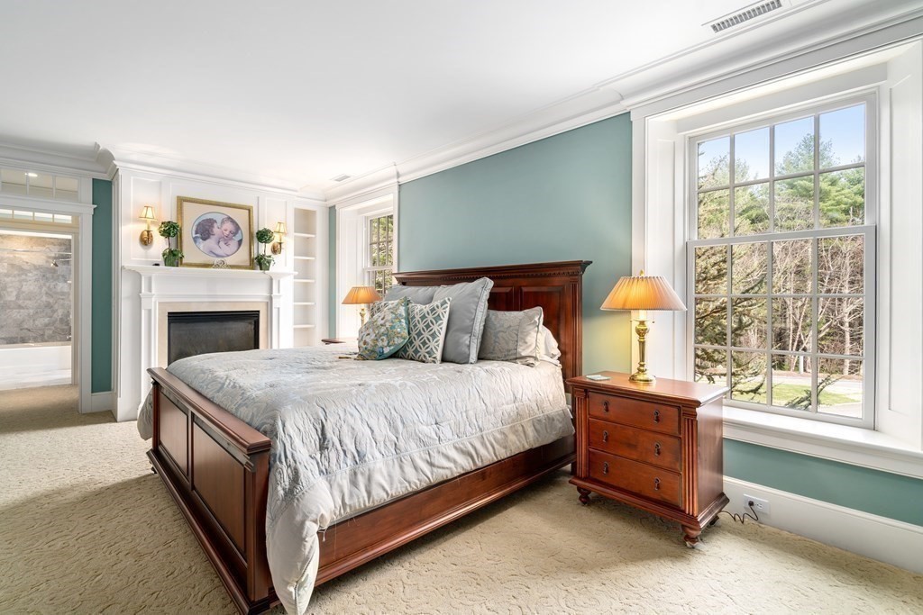 145 Dutton Road Sudbury, MA 01776 - Photo 26 of 41 a bedroom with a bed and a fireplace