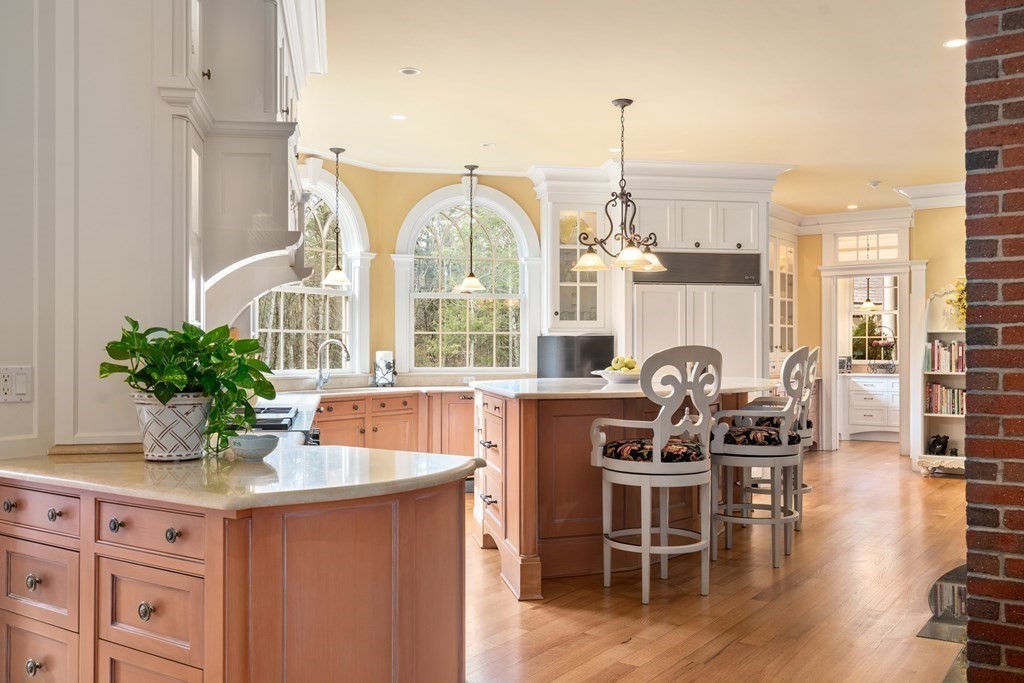145 Dutton Road Sudbury, MA 01776 - Photo 6 of 41 a kitchen with stainless steel appliances granite countertop a table and chairs in it