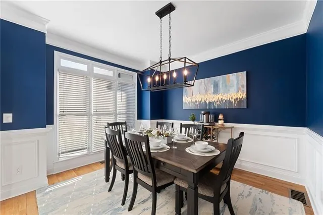 a view of a dining room with furniture wooden floor and chandelier