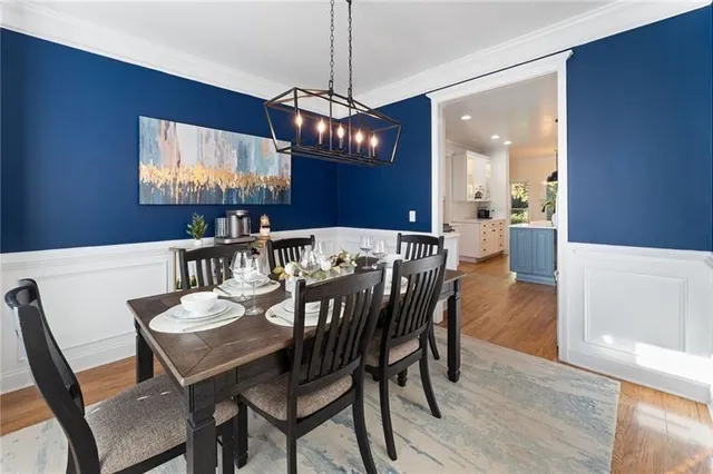 a view of a dining room with furniture window and wooden floor