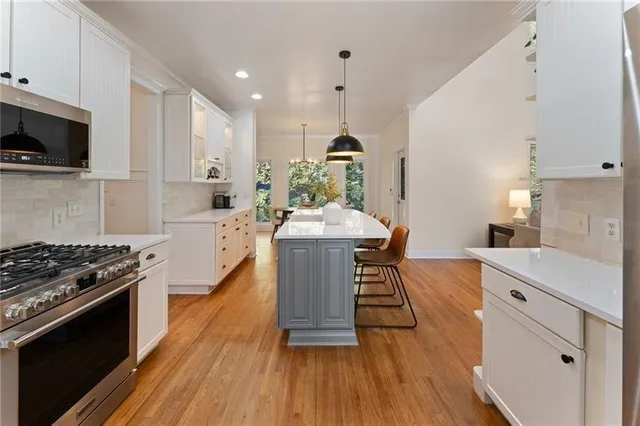 a kitchen with sink stove and cabinets