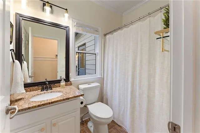 a spacious bedroom with a large bed and a chandelier