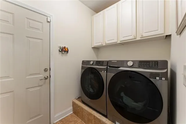 a spacious bedroom with a bed and a chandelier