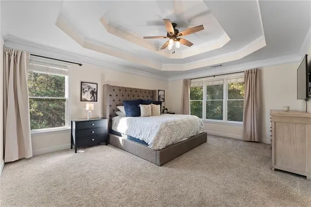 a large bathroom with a tub sink and glass door
