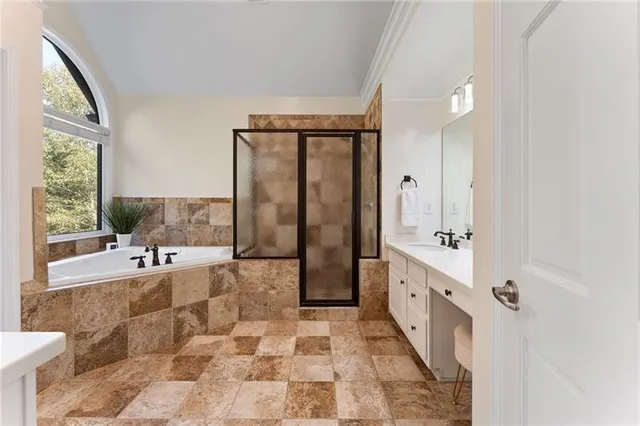 a en suite bathroom with a sink double vanity and a mirror