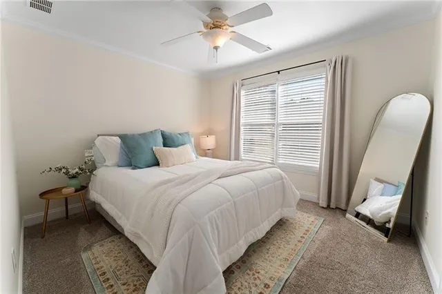 a bed sitting in a bedroom next to a window