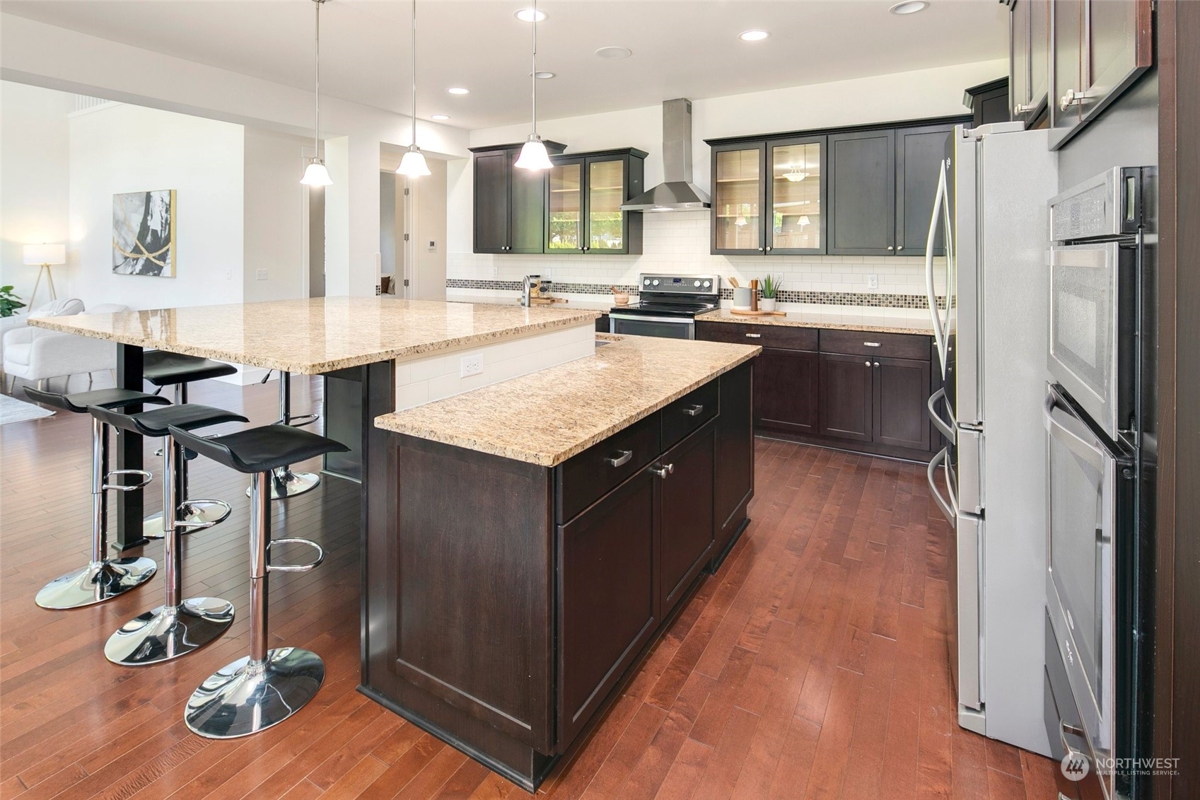 5226 Northeast 2nd Street Renton, WA 98059 - Photo 6 of 40 a kitchen with kitchen island granite countertop a sink appliances and cabinets