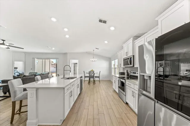 a large kitchen with stainless steel appliances lots of counter space and breakfast area