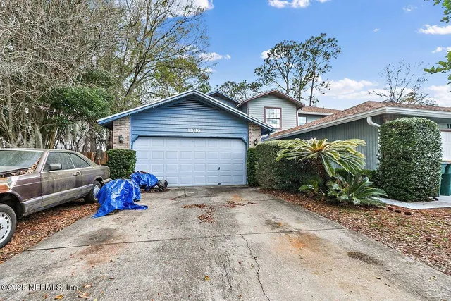 a view of a car park in front of a house