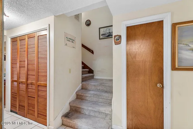 a bedroom with a bed a large window and book shelf