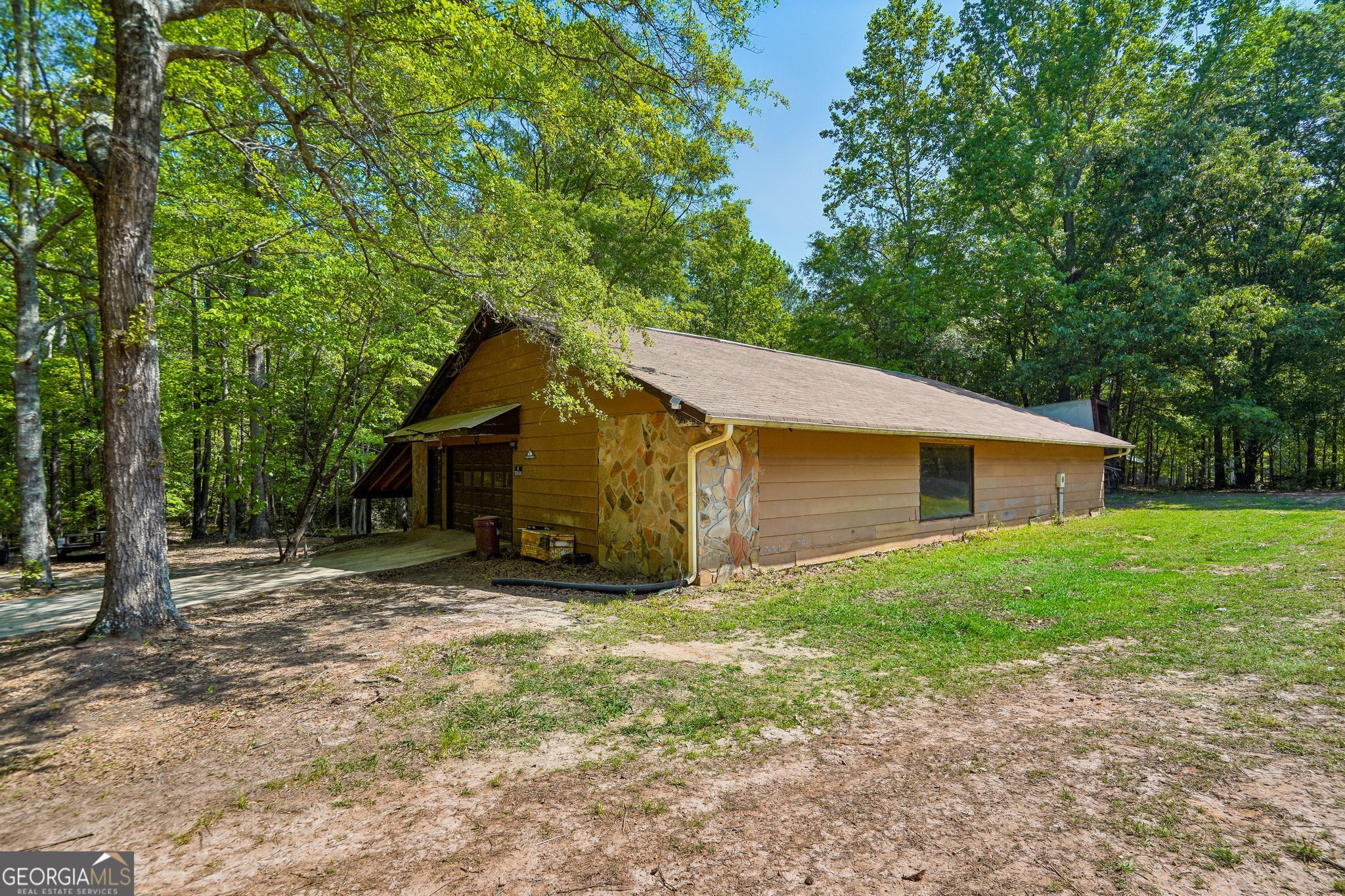 241 Busbin Road Fayetteville, GA 30215 - Photo 31 of 45 a yellow house in middle of the forest