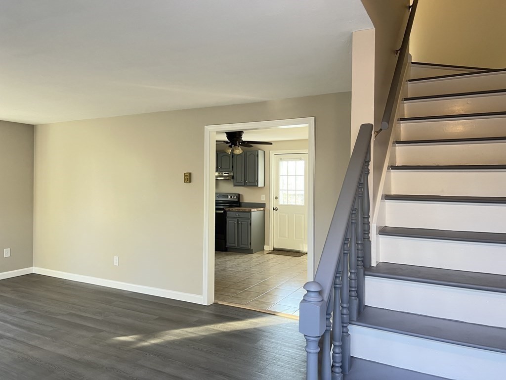 1124 Bemis Road, Unit B Warren, MA 01585 - Photo 21 of 42 a view of a hallway with wooden floor and staircase