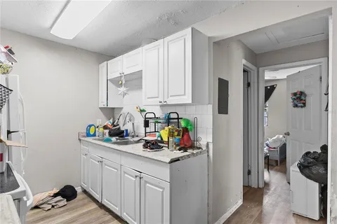 a kitchen with a refrigerator and a sink