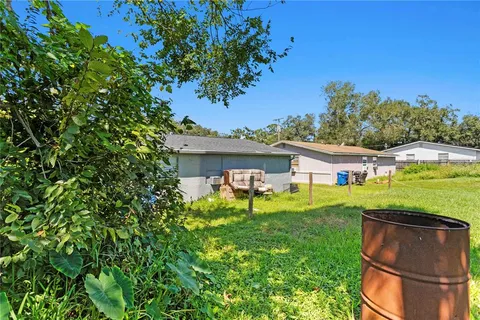 a view of a house with a backyard