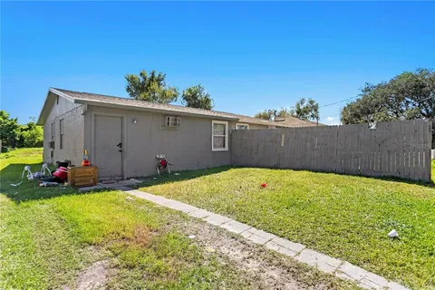 a view of a backyard with plants and a bench