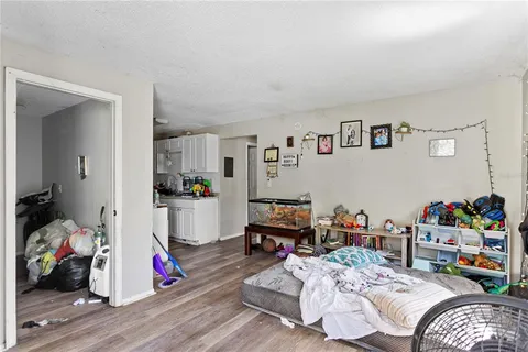 a bedroom with bed and wooden floor