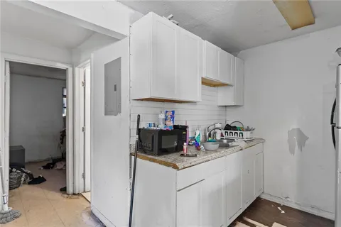 a kitchen with stainless steel appliances granite countertop a sink stove and cabinets