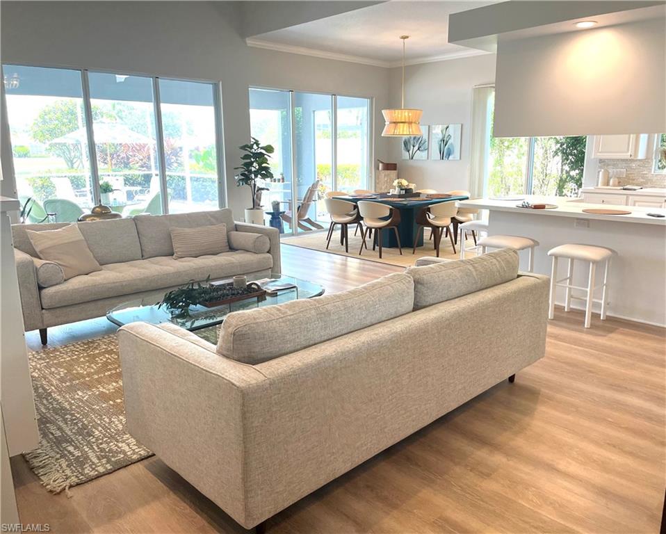 5477 Freeport Lane Naples, FL 34119 - Photo 7 of 36 a living room with furniture and a large window