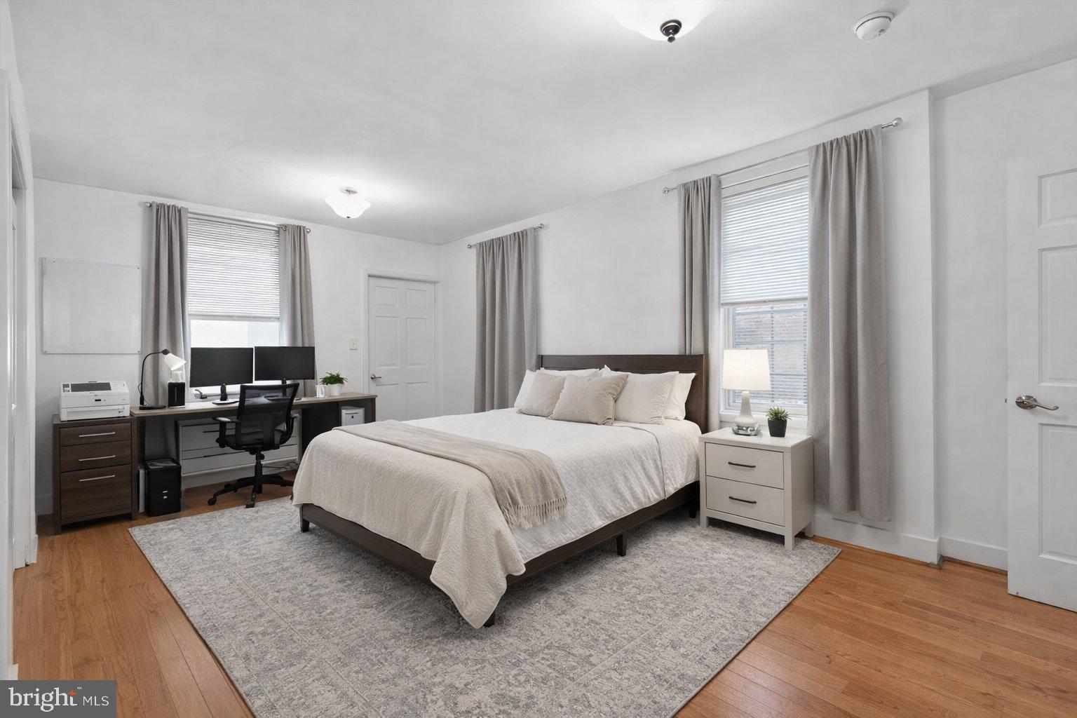 1431 Spruce Street, Unit 1R Philadelphia, PA 19102 - Photo 12 of 20 a bedroom with a bed and wooden floor