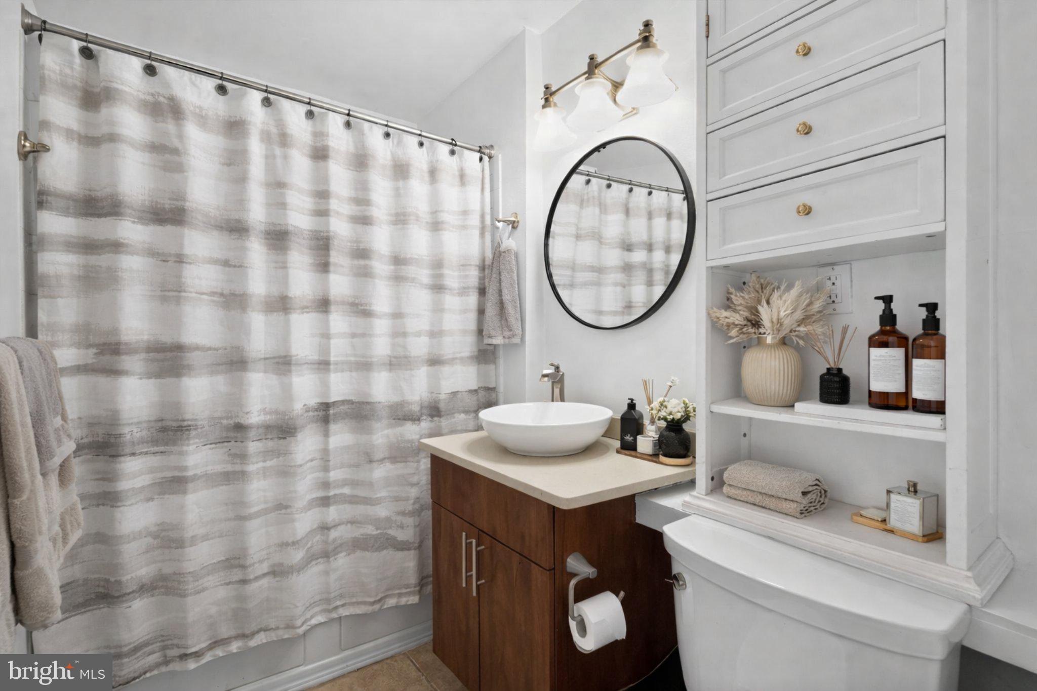 1431 Spruce Street, Unit 1R Philadelphia, PA 19102 - Photo 15 of 20 a bathroom with a sink and a mirror
