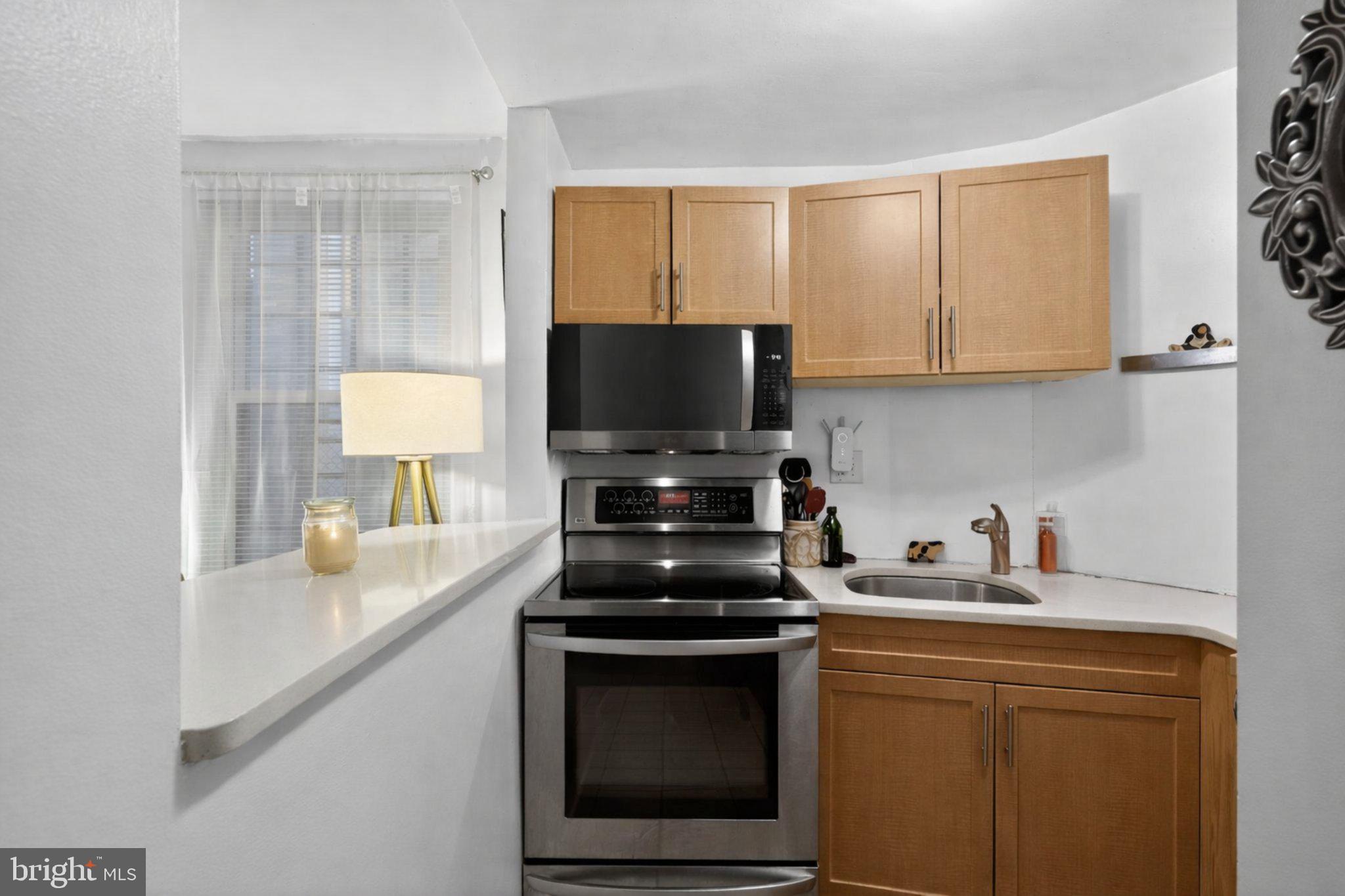 1431 Spruce Street, Unit 1R Philadelphia, PA 19102 - Photo 8 of 20 a kitchen with a sink a stove and cabinets