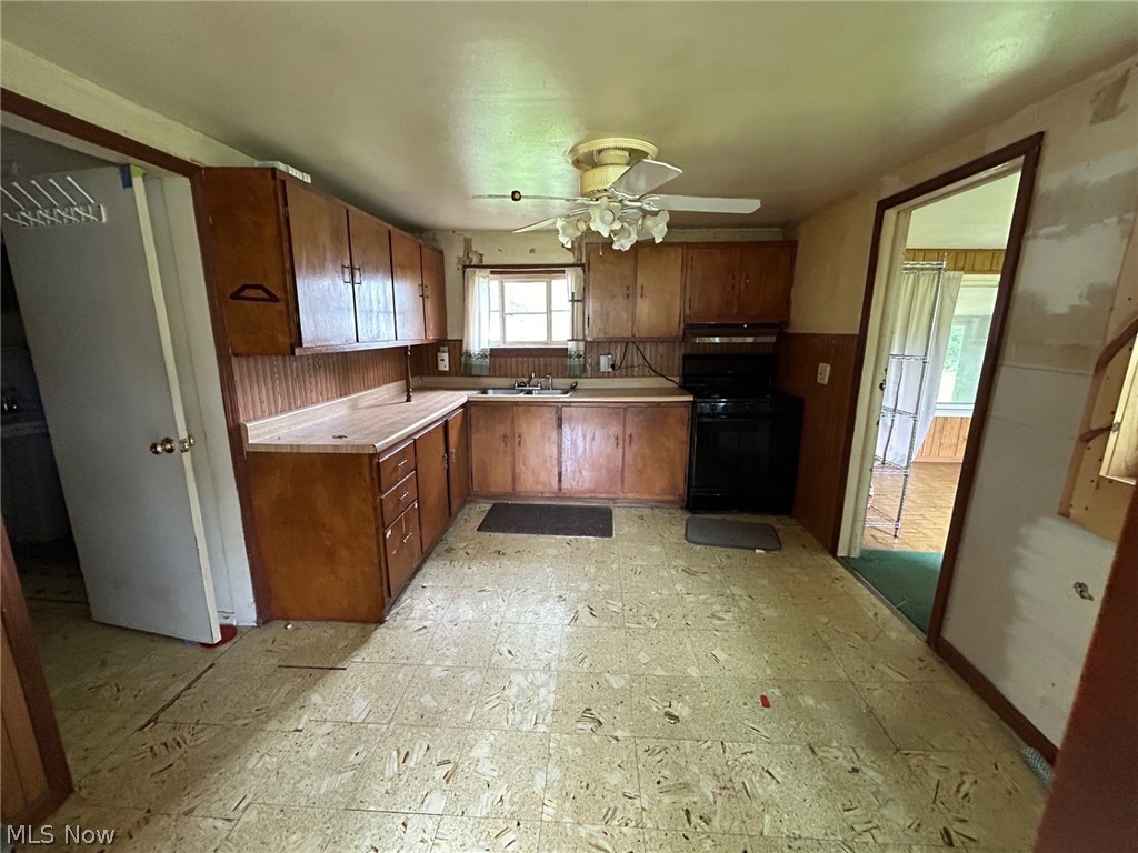 4106 Jaeger Road Lorain, OH 44053 - Photo 3 of 17 Kitchen featuring sink, black stove, ceiling fan, and light tile flooring