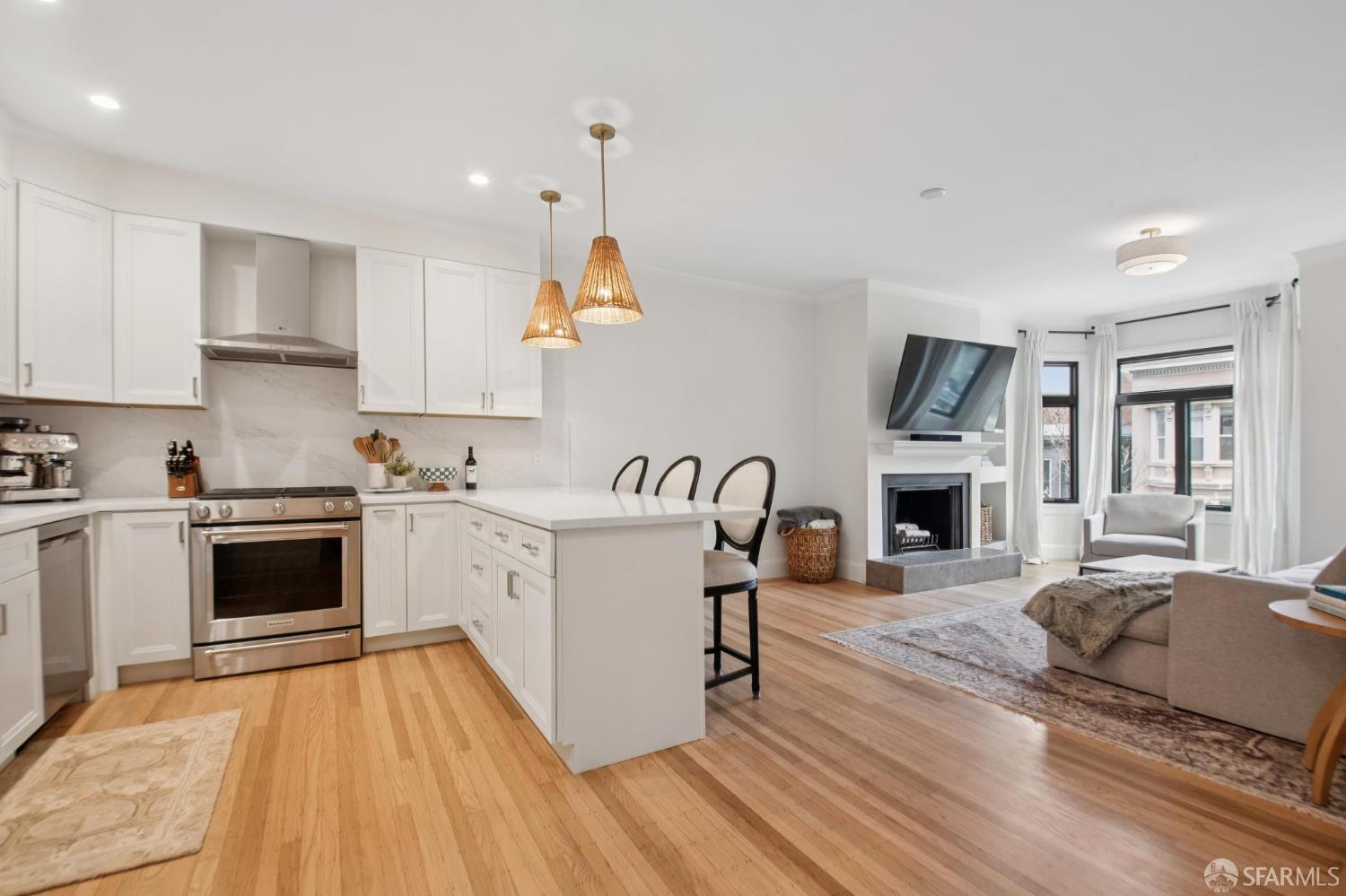 a kitchen with furniture a stove and a wooden floors