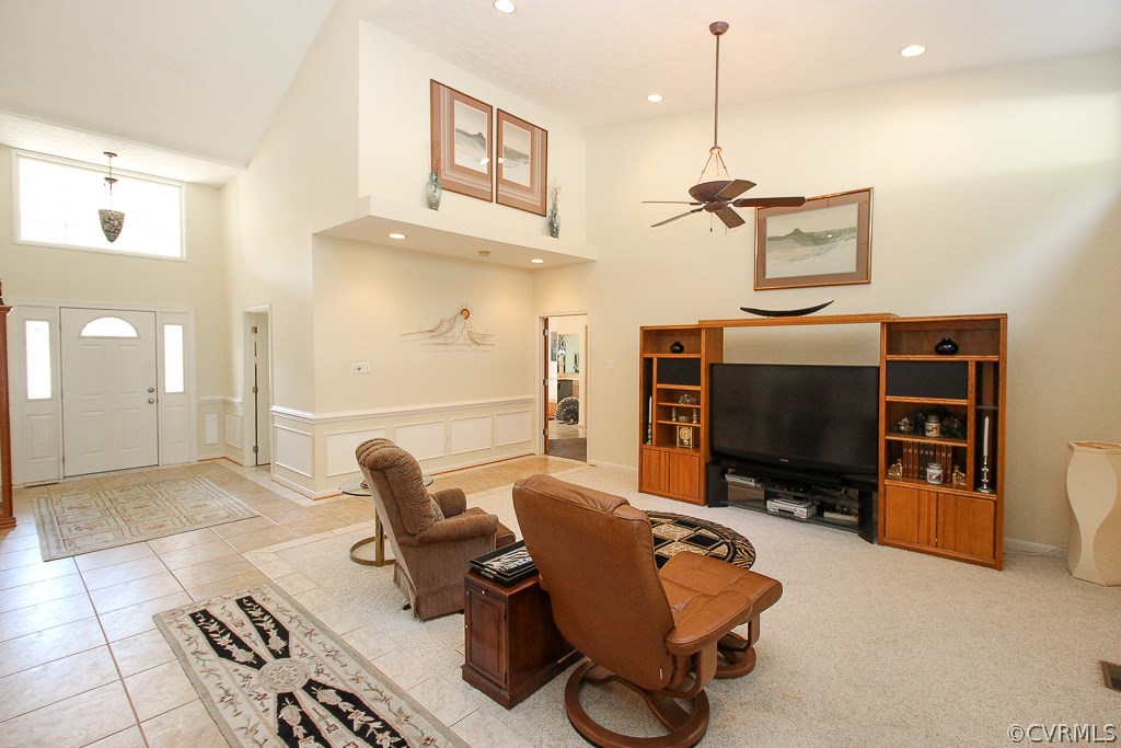 12600 Lilking Road Chester, VA 23831 - Photo 11 of 25 a living room with furniture a flat screen tv and gym equipment