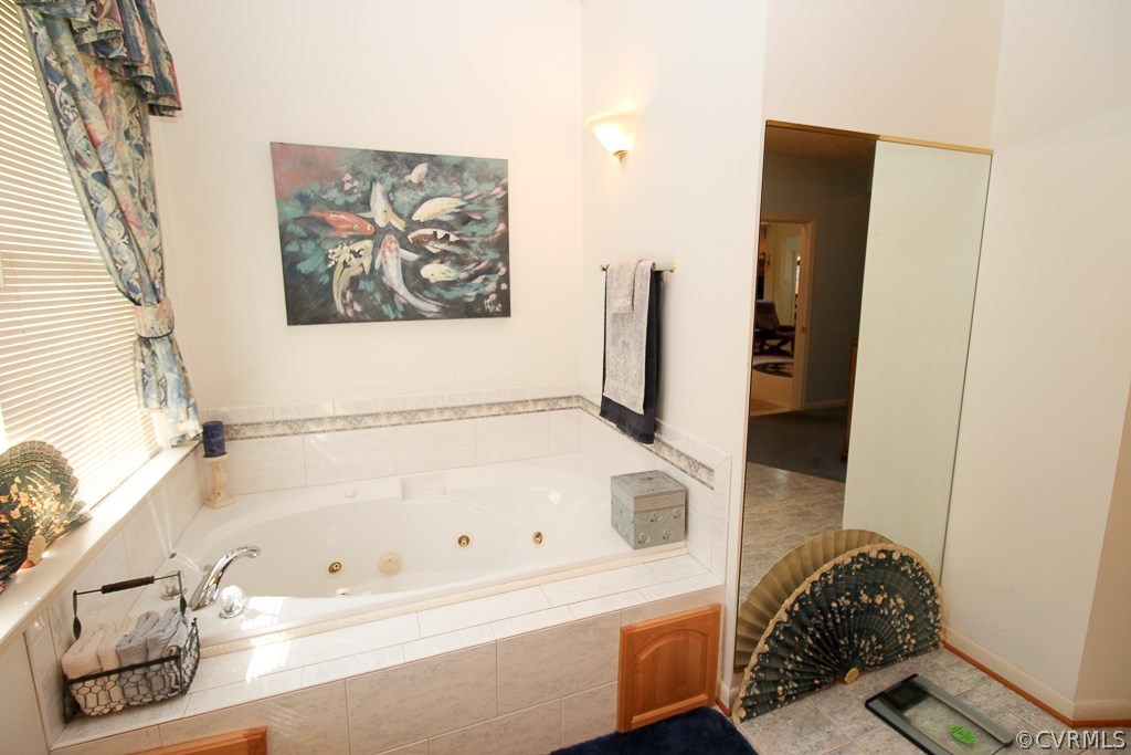 12600 Lilking Road Chester, VA 23831 - Photo 22 of 25 a bathroom with a tub and a shower curtain
