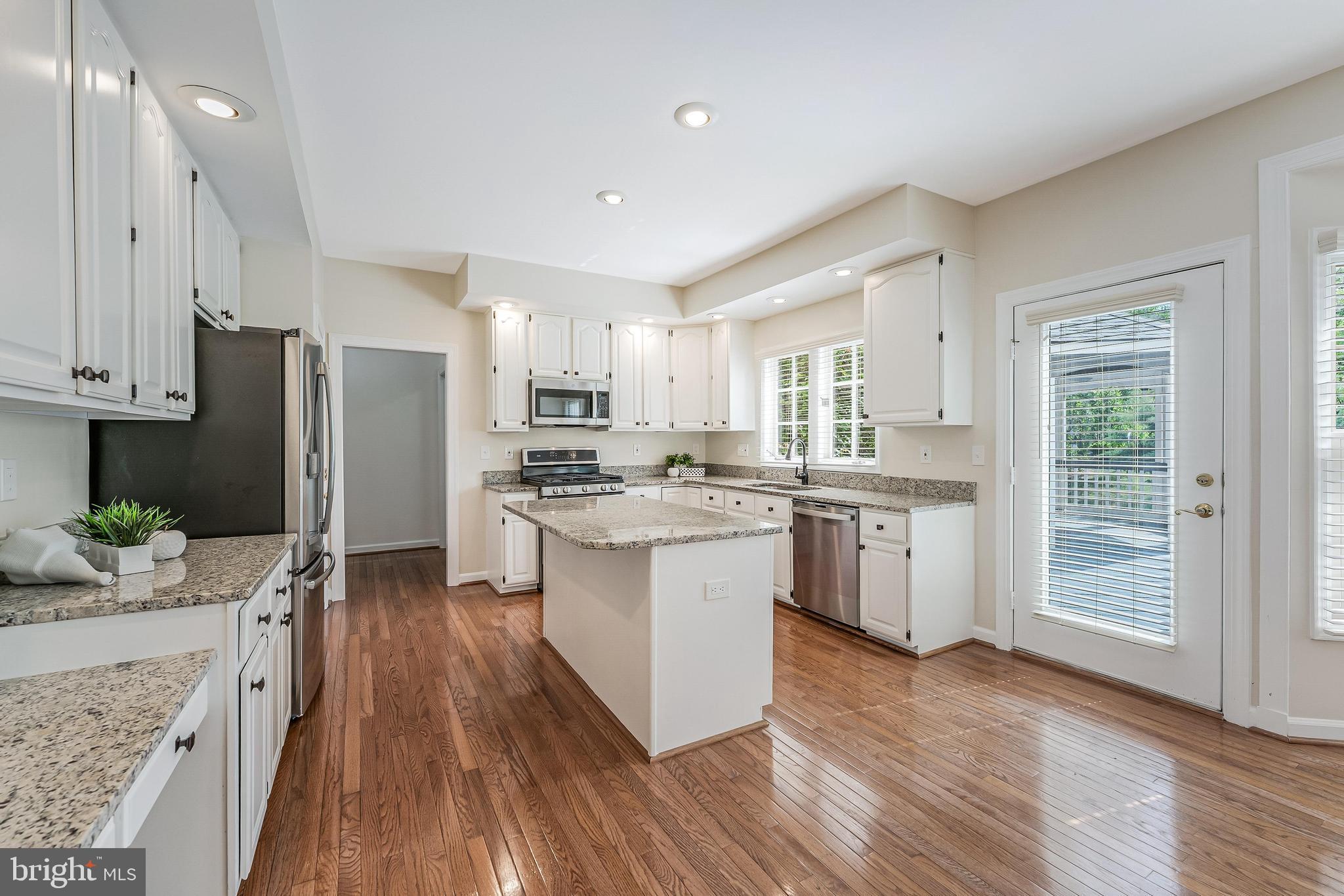 5501 Ashleigh Road Fairfax, VA 22030 - Photo 30 of 77 a kitchen with stainless steel appliances a refrigerator sink and wooden floor