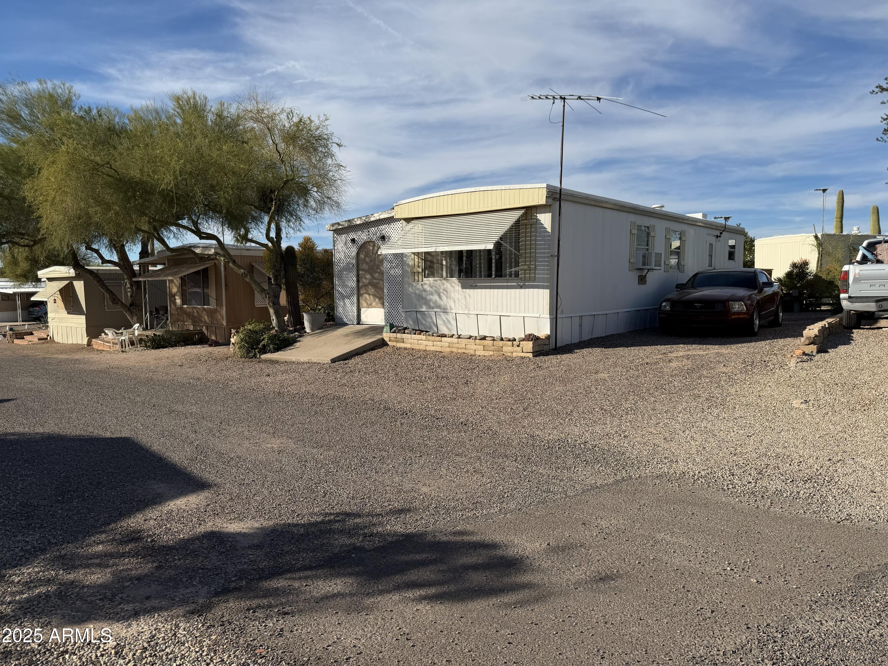 939 North Acacia Road, Unit 20 Apache Junction, AZ 85119 - Photo 2 of 10 a view of a car park in front of house