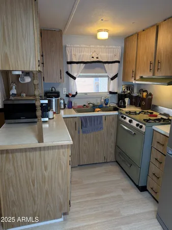 a kitchen with a stove a sink and a refrigerator
