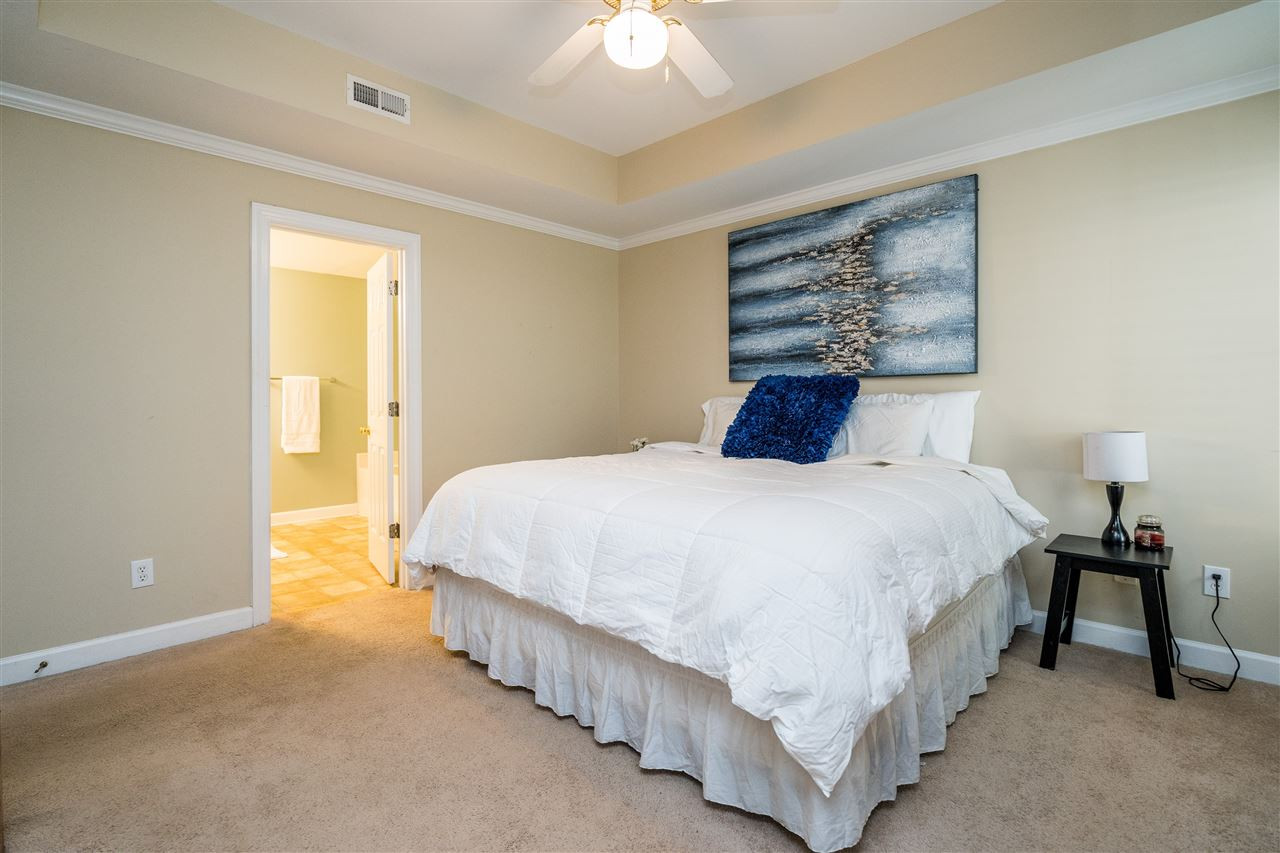 7016 Sandy Forks Road, Unit 201 Raleigh, NC 27609 - Photo 17 of 28 Enjoy this beautiful master suite with tray ceiling, plenty of natural light, ceiling fan and access to private balcony! Master Bedroom