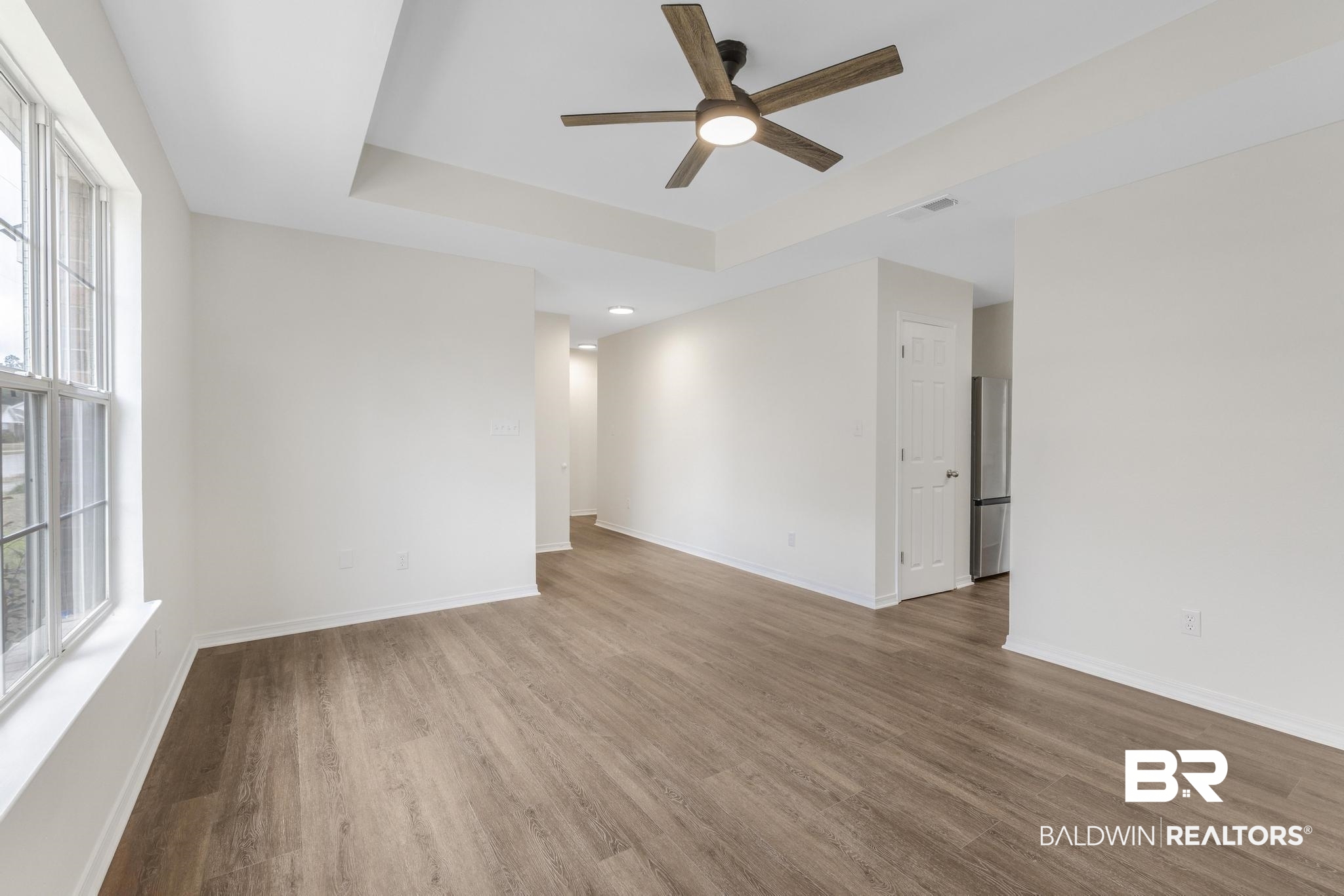 16330 Absalom Street Foley, AL 36535 - Photo 15 of 42 Unfurnished room featuring a tray ceiling, wood-type flooring, and ceiling fan
