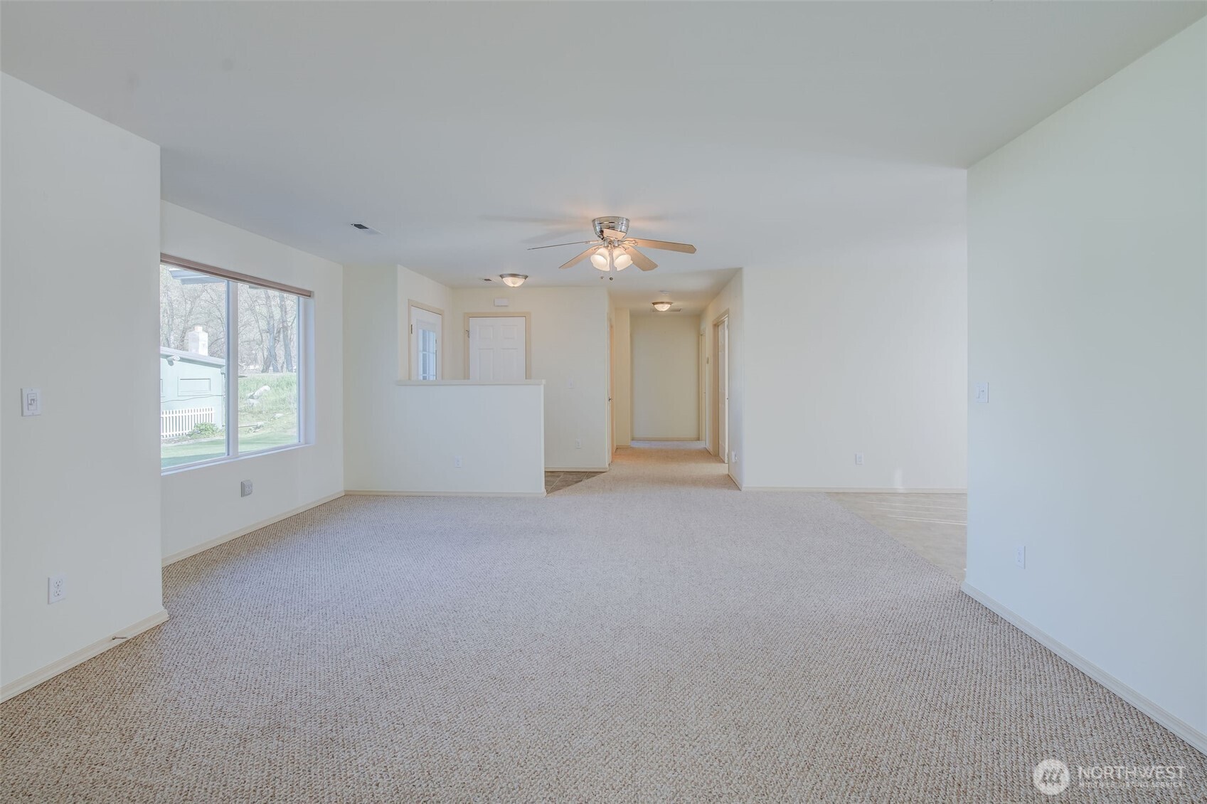 224 Vine Street Cashmere, WA 98815 - Photo 11 of 35 an empty room with windows and chandelier fan
