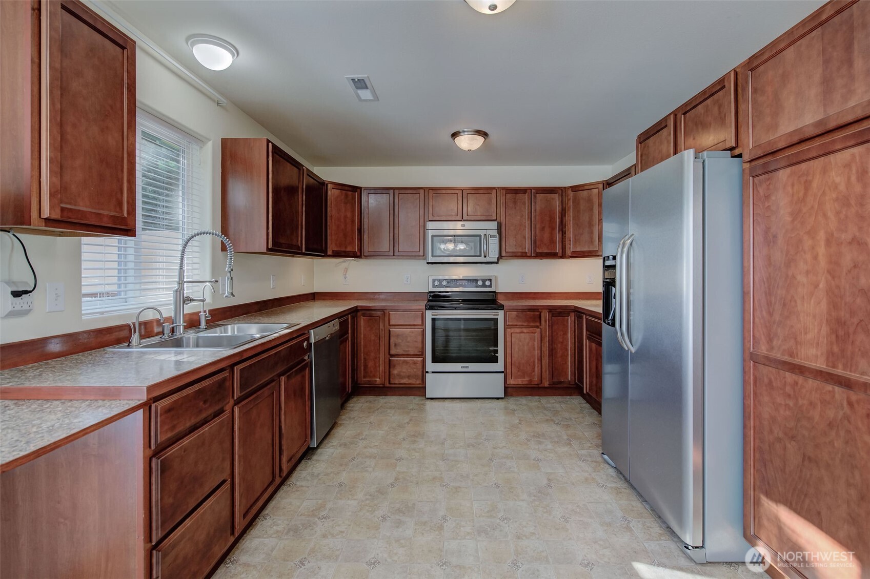 224 Vine Street Cashmere, WA 98815 - Photo 14 of 35 a large kitchen with stainless steel appliances granite countertop a stove top oven a sink and dishwasher a refrigerator with wooden cabinets