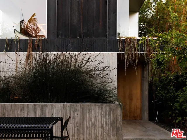 a wooden bench sitting in front of a building