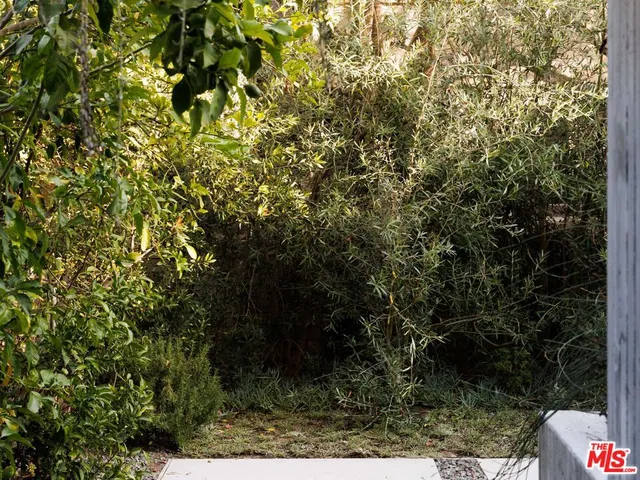 a view of a balcony with table and chairs and wooden fence