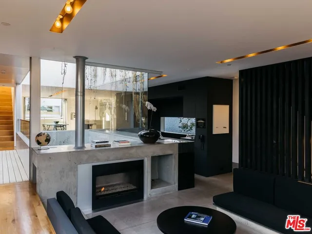 a living room with furniture a lamp and a fireplace