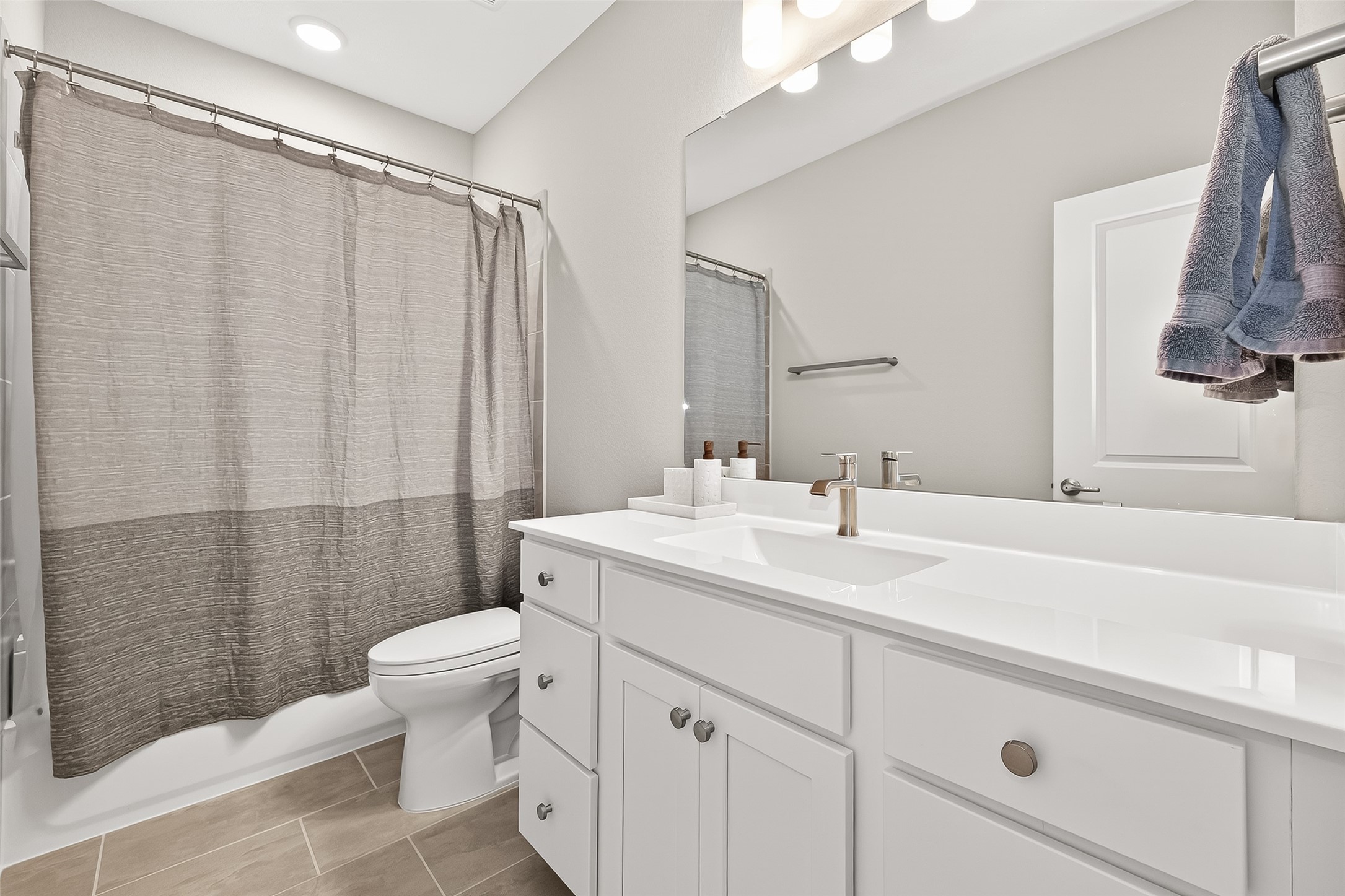 11226 Common Hackberry Street Cypress, TX 77433 - Photo 12 of 17 a bathroom with a sink toilet and shower