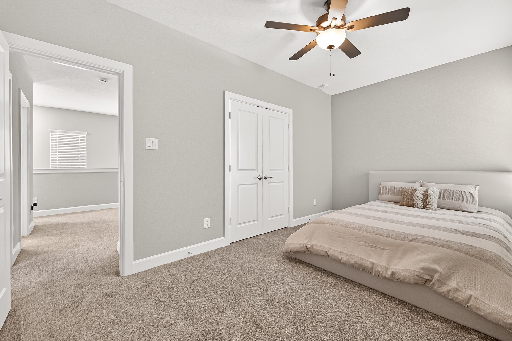 11226 Common Hackberry Street Cypress, TX 77433 - Photo 13 of 17 a bedroom with a bed and a chandelier