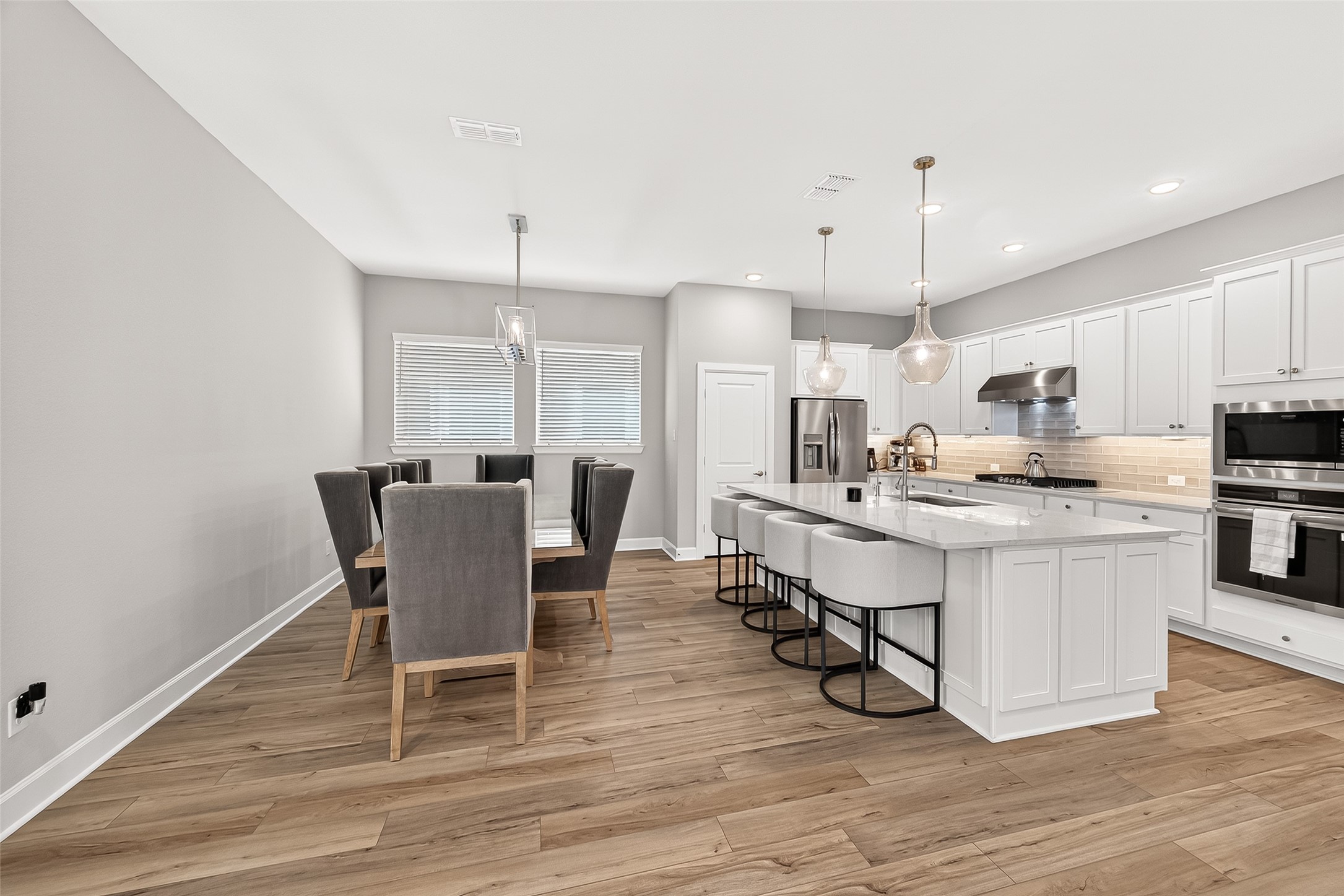 11226 Common Hackberry Street Cypress, TX 77433 - Photo 7 of 17 a view of kitchen with cabinets table and chairs