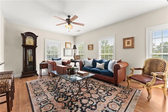 a living room with furniture a rug and a window