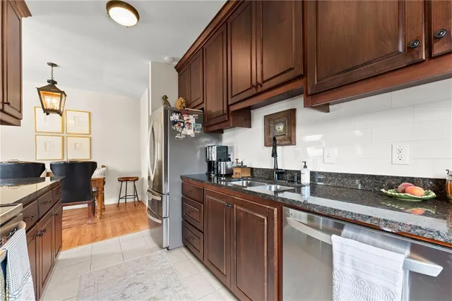 a kitchen with stainless steel appliances granite countertop a sink stove and cabinets