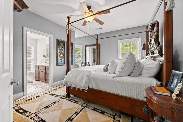 a spacious bedroom with a bed window and a table