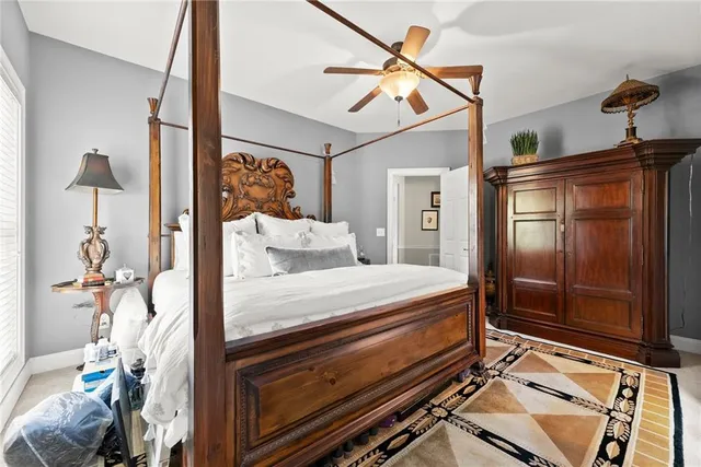 a bedroom with a bed and a mirror on the dresser